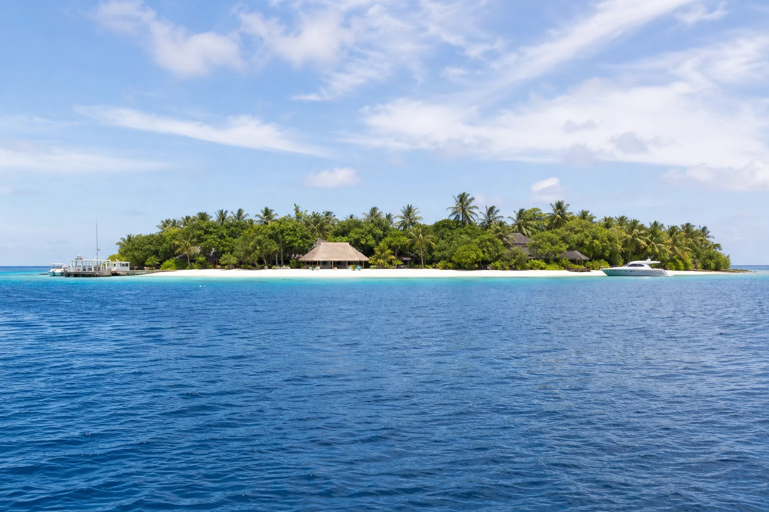 Fictional exclusive-use Maldives island with villas, service jetty and yacht